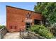 Brick building exterior with 'Monday Night Garage' signage, outdoor seating, and metal stairs at 1599 Mayflower Sw Ave, Atlanta, GA 30311