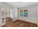 Hardwood floors enhance this living area with white trim and open access to adjacent room at 1599 Mayflower Sw Ave, Atlanta, GA 30311