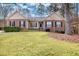 Charming home with brick accents, black shutters, and lush green lawn at 1688 Vinings Ct, Lawrenceville, GA 30043