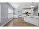 Living room view of kitchen featuring a breakfast bar, pendant lights, and hardwood floors at 1688 Vinings Ct, Lawrenceville, GA 30043