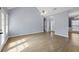 Spacious living room featuring hardwood floors, light gray walls, and natural light from the windows at 1688 Vinings Ct, Lawrenceville, GA 30043