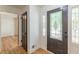 Welcoming foyer with hardwood floors, a decorative front door, and a glimpse into adjacent rooms at 418 Mockingbird, Smyrna, GA 30082