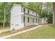Side view of the home showcasing the 2-car garage and white brick elevation at 418 Mockingbird, Smyrna, GA 30082