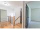Open hallway with modern lighting fixture, and iron and wood railing at 418 Mockingbird, Smyrna, GA 30082