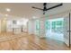 Open-concept living space flows into a modern kitchen and screened porch with a ceiling fan at 418 Mockingbird, Smyrna, GA 30082