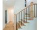 Bright foyer with hardwood floors and staircase featuring modern black metal railings at 418 Mockingbird, Smyrna, GA 30082