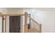 Wooden staircase with black metal balusters and wooden handrail; view of entry door at 418 Mockingbird, Smyrna, GA 30082
