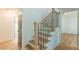 Elegant staircase with wooden steps and black iron railings, complemented by bright, neutral walls at 418 Mockingbird, Smyrna, GA 30082