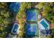 Aerial view of tennis courts and pool surrounded by trees at 868 Clarion Way, Lawrenceville, GA 30044