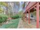 Backyard showing porch supports, green grass, landscaped bed, and small stone path at 868 Clarion Way, Lawrenceville, GA 30044