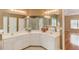 Bathroom features a double vanity, large mirror, and tiled shower at 868 Clarion Way, Lawrenceville, GA 30044