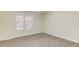 Bright bedroom with a large window and modern gray wood flooring at 868 Clarion Way, Lawrenceville, GA 30044