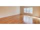 Cozy bedroom with hardwood floors and a large window offering plenty of natural light at 868 Clarion Way, Lawrenceville, GA 30044