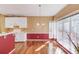 Bright kitchen and breakfast area featuring wood floors, white cabinets, and natural light with a view of trees outside at 868 Clarion Way, Lawrenceville, GA 30044