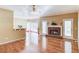 Spacious living room featuring hardwood floors, a cozy brick fireplace, and natural light from the doors and windows at 868 Clarion Way, Lawrenceville, GA 30044