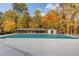 Community pool covered in green tarp surrounded by Autumn trees, covered gazebo and pool house at 868 Clarion Way, Lawrenceville, GA 30044