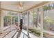 Light-filled sunroom with tile floor and views of wooded backyard at 868 Clarion Way, Lawrenceville, GA 30044