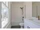 Modern bathroom features stylish white cabinets, a sleek black shower, and a bright window view at 3165 Old Jonesboro Rd, Hapeville, GA 30354