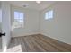 Bright bedroom with hardwood floors and two windows overlooking a beautiful outdoor scene at 3165 Old Jonesboro Rd, Hapeville, GA 30354
