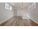 Bright dining room with modern chandelier, wood floors, and wainscoting at 3165 Old Jonesboro Rd, Hapeville, GA 30354