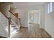 Bright foyer with hardwood floors, white walls and wooden staircase at 3165 Old Jonesboro Rd, Hapeville, GA 30354