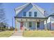 Charming two-story home featuring a welcoming front porch, ceiling fans, and a well-maintained front yard at 3165 Old Jonesboro Rd, Hapeville, GA 30354