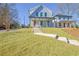 Charming two-story home featuring a welcoming front porch and a well-maintained lawn and stairway at 3165 Old Jonesboro Rd, Hapeville, GA 30354