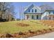 Charming two-story home featuring a welcoming front porch and a well-maintained front yard at 3165 Old Jonesboro Rd, Hapeville, GA 30354