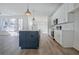 Modern kitchen with hardwood floors, white cabinets, and stainless-steel appliances at 3165 Old Jonesboro Rd, Hapeville, GA 30354