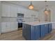Modern kitchen featuring a center island, stone countertops, stainless steel appliances, pendant lighting, and white cabinetry at 3165 Old Jonesboro Rd, Hapeville, GA 30354