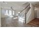 Open-concept living room with hardwood floors, a ceiling fan, and many windows at 3165 Old Jonesboro Rd, Hapeville, GA 30354