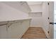 Walk-in closet with custom shelving and hardwood flooring provides organized storage solutions at 3165 Old Jonesboro Rd, Hapeville, GA 30354