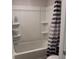 Clean bathroom featuring a white tub-shower combination and a striped shower curtain at 7266 Gladstone Cir, Lithonia, GA 30038