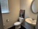 Powder room with pedestal sink and modern fixtures at 7266 Gladstone Cir, Lithonia, GA 30038