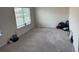 Cozy room with a large window providing natural light, neutral carpet and walls, a large yoga ball and a few weights at 7266 Gladstone Cir, Lithonia, GA 30038