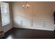 Bright dining room featuring hardwood floors, wainscotting, and a large window at 7266 Gladstone Cir, Lithonia, GA 30038