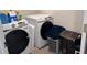 Laundry room with a front loading washer and dryer and neutral tone flooring at 7266 Gladstone Cir, Lithonia, GA 30038
