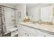 Bathroom featuring a granite countertop, white cabinets, decorative flowers, and a shower-tub combination at 783 Cygnet Ln, Grayson, GA 30017