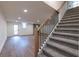 Basement stairs that lead to a finished basement with wood floors, fireplace, and walkout door at 5548 Martina Way, Atlanta, GA 30338