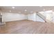 Spacious finished basement with wood flooring, fireplace, stairs, and recessed lights at 5548 Martina Way, Atlanta, GA 30338
