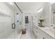 A modern bathroom with marble tiled walls and a frameless glass shower enclosure at 5548 Martina Way, Atlanta, GA 30338