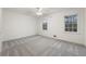 Spacious bedroom features soft carpet, a ceiling fan, and natural light from two windows at 5548 Martina Way, Atlanta, GA 30338