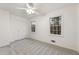 Cozy bedroom features plush carpet, a ceiling fan, and two large windows at 5548 Martina Way, Atlanta, GA 30338