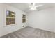 Serene bedroom with neutral carpet, ceiling fan, and windows overlooking the yard at 5548 Martina Way, Atlanta, GA 30338