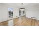 Modern dining room featuring hardwood floors, updated lighting, and large windows with neighborhood views at 5548 Martina Way, Atlanta, GA 30338