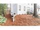 Charming white brick home featuring a side entry and beautifully landscaped yard with mature trees at 5548 Martina Way, Atlanta, GA 30338