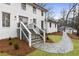 Charming exterior view showcasing the stone walkway, black-framed windows, and freshly landscaped front yard at 5548 Martina Way, Atlanta, GA 30338