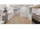 Spacious kitchen featuring stainless steel appliances, granite countertops, modern cabinetry and hardwood floors at 5548 Martina Way, Atlanta, GA 30338