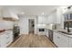 Bright, renovated kitchen with custom white cabinets, modern appliances, and stunning hardwood floors at 5548 Martina Way, Atlanta, GA 30338