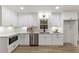 All-white kitchen features stainless steel appliances, granite countertops, and modern cabinetry at 5548 Martina Way, Atlanta, GA 30338